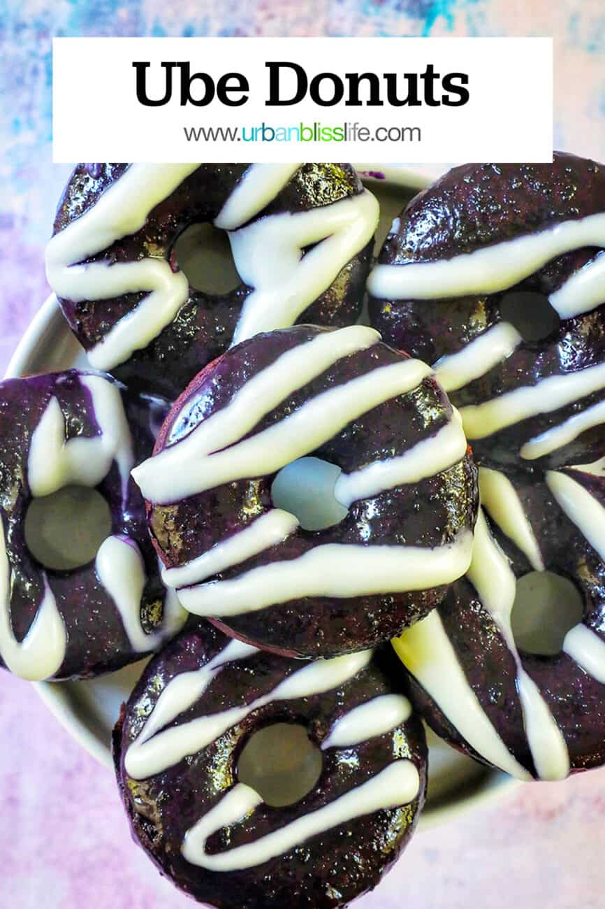 several ube donuts with ube glaze and white glaze drizzle and title text overlay.