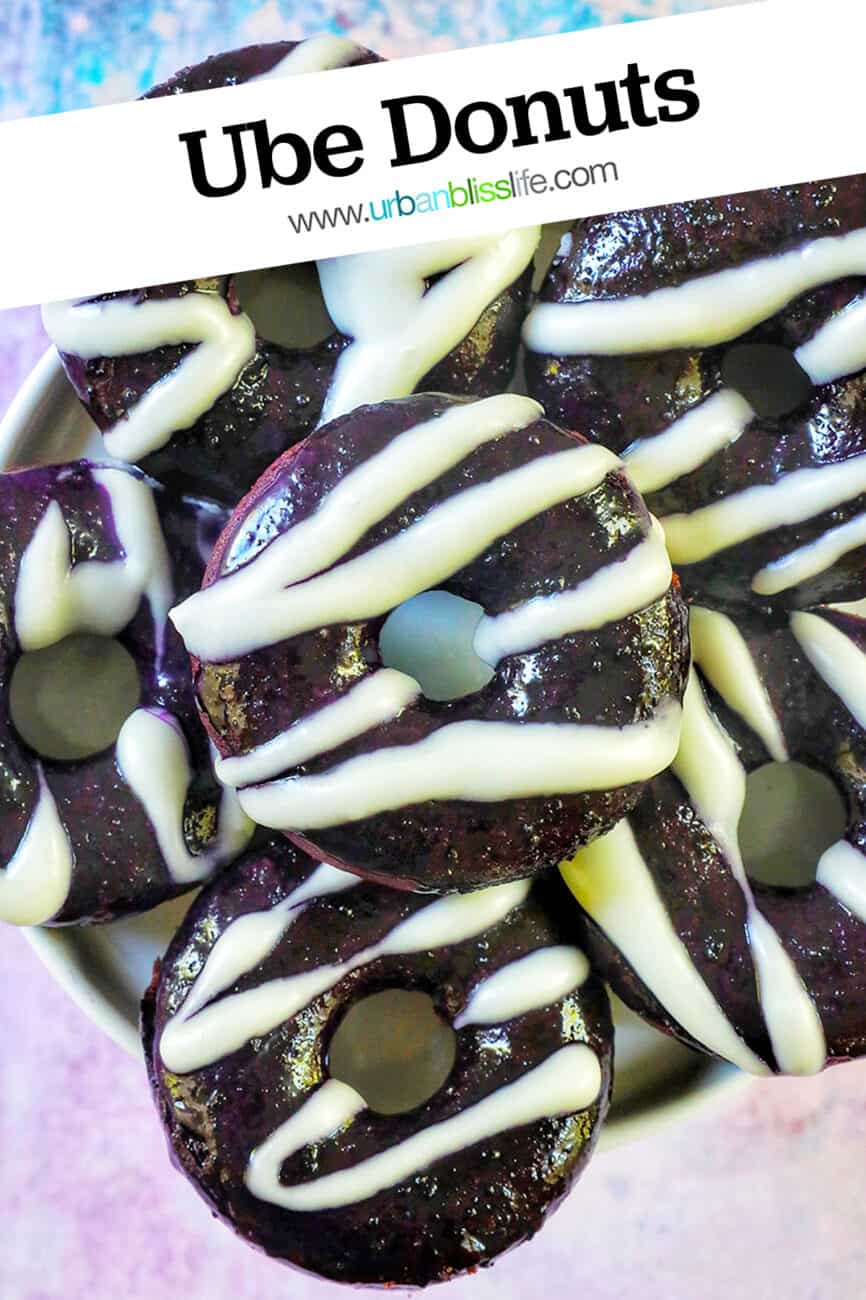 several ube donuts with ube glaze and white glaze drizzle with title text overlay.