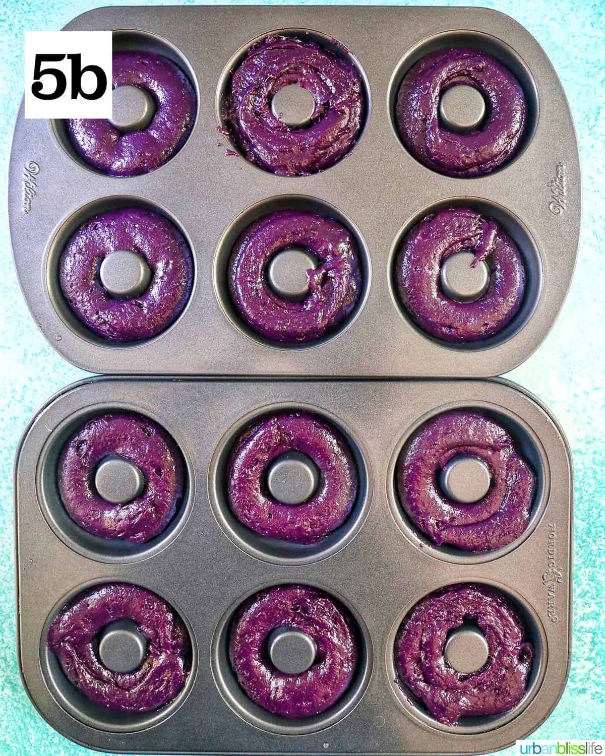 two donut pans filled with purple ube batter.