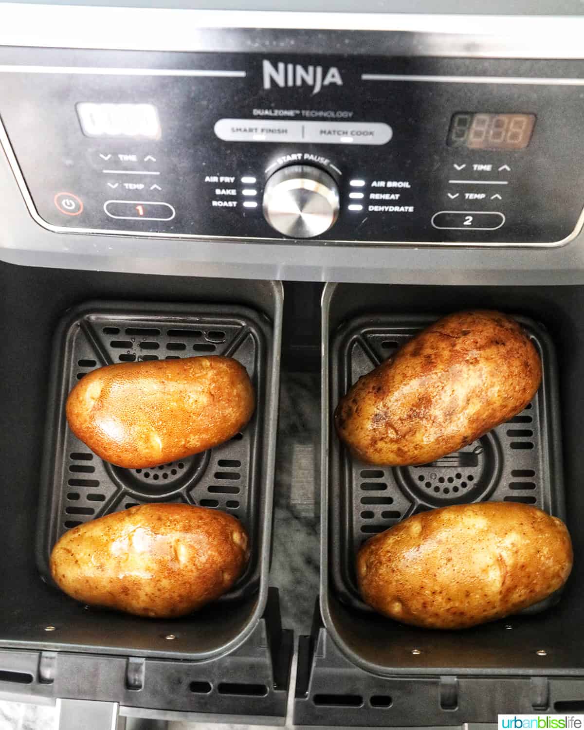 four potatoes in an air fryer.