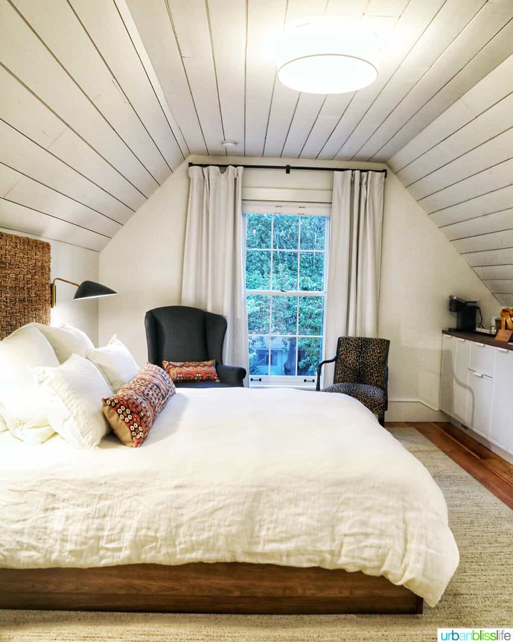 side view of the bed, chairs, and kitchenette in at Kubli Haus Suite 3 in Jacksonville Oregon.