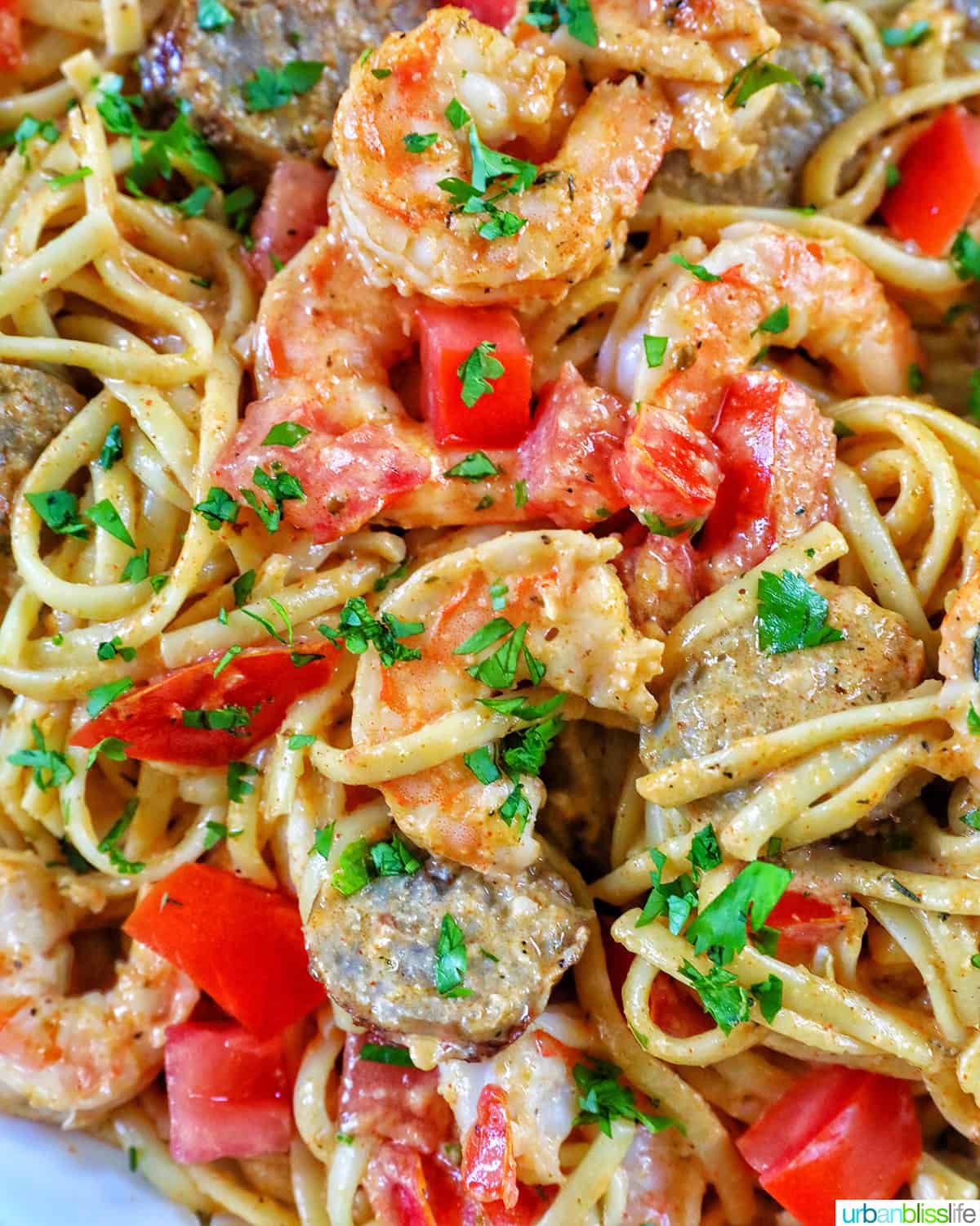 large serving platter of shrimp and sausage pasta.