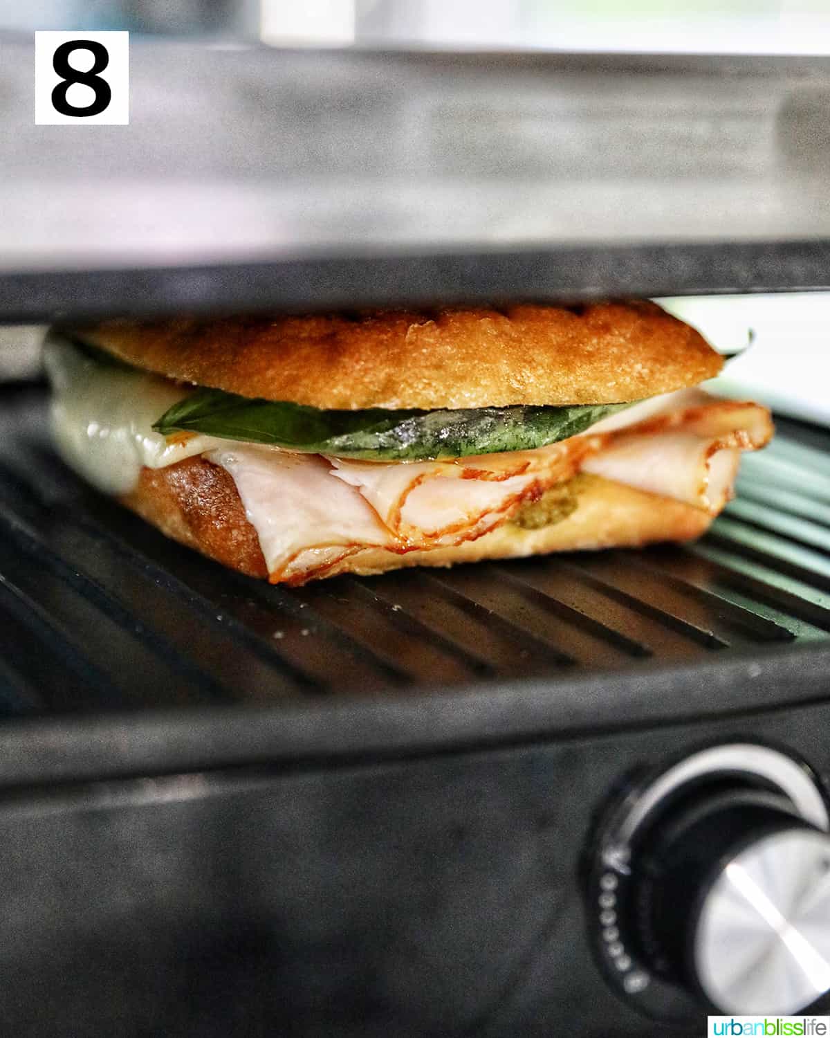 turkey pesto sandwich in a panini press.