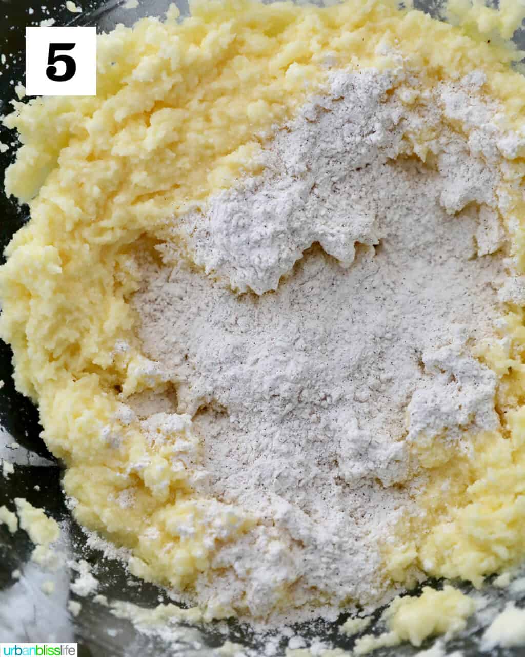 adding dry ingredients to wet ingredients.
