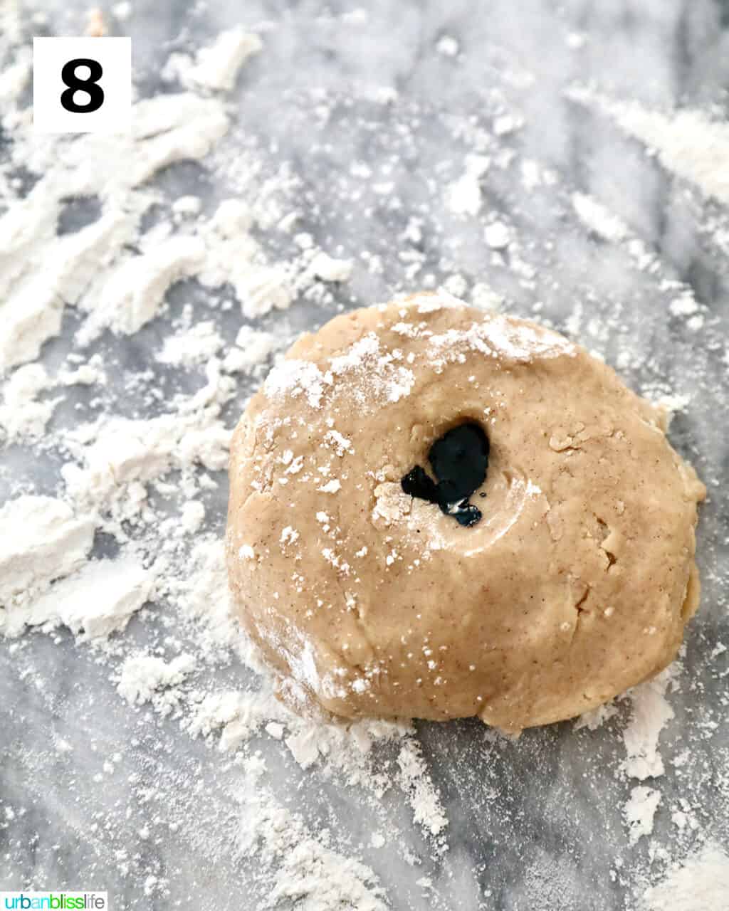adding purple food coloring to cookie dough