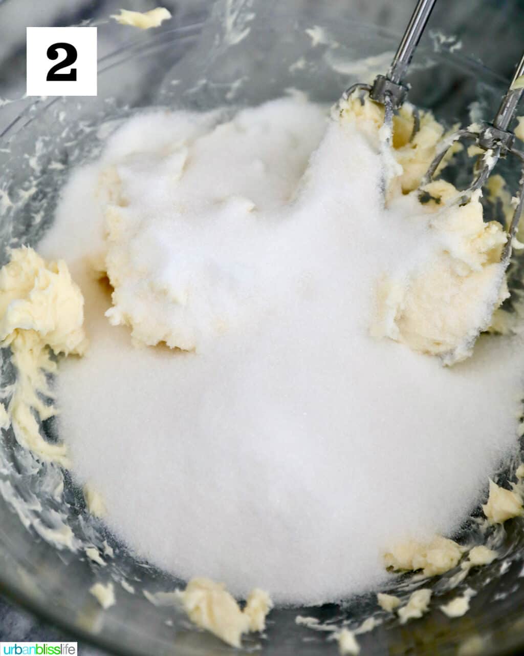 adding sugar to butter