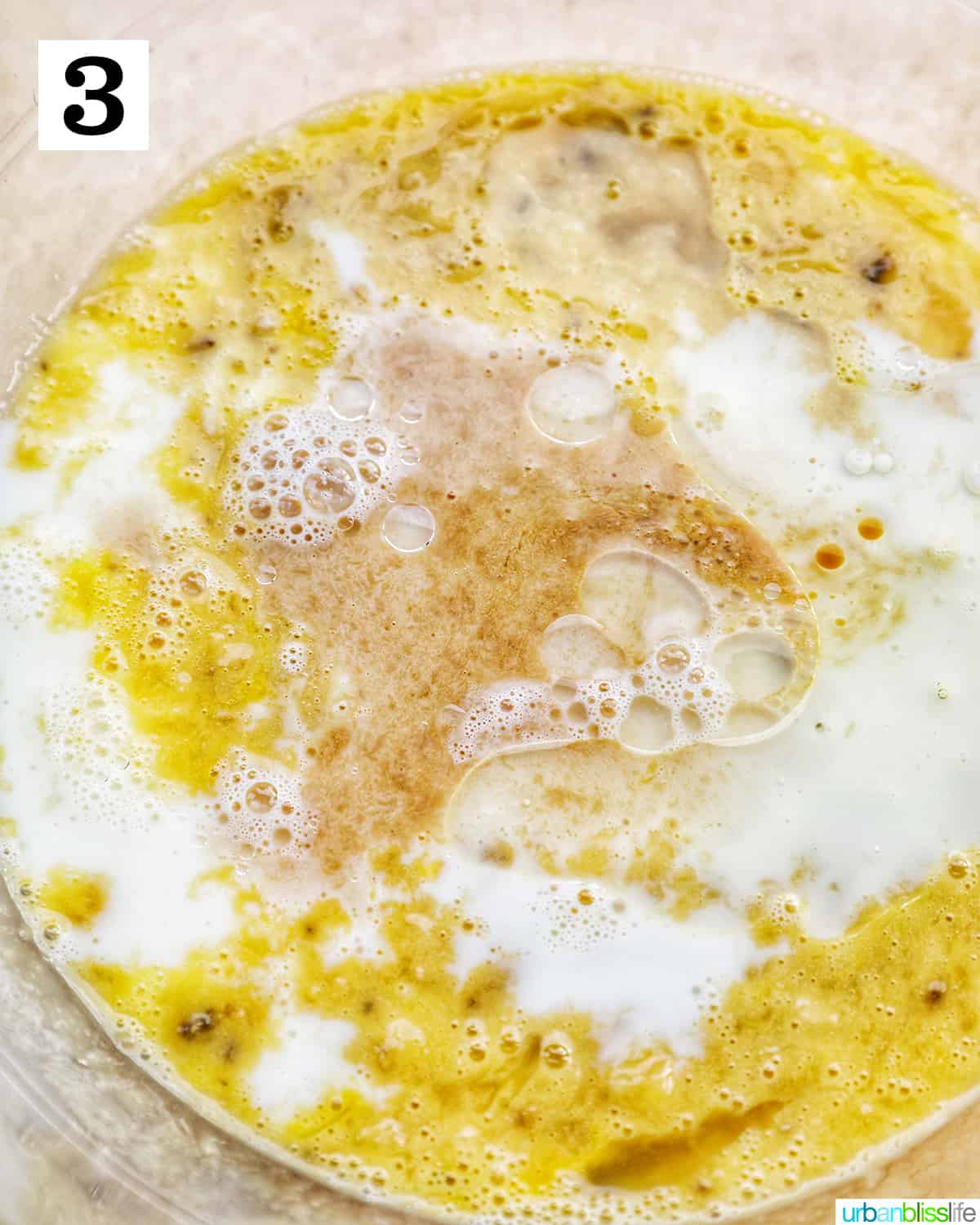 yogurt and milk added to mashed banana mixture in a bowl.