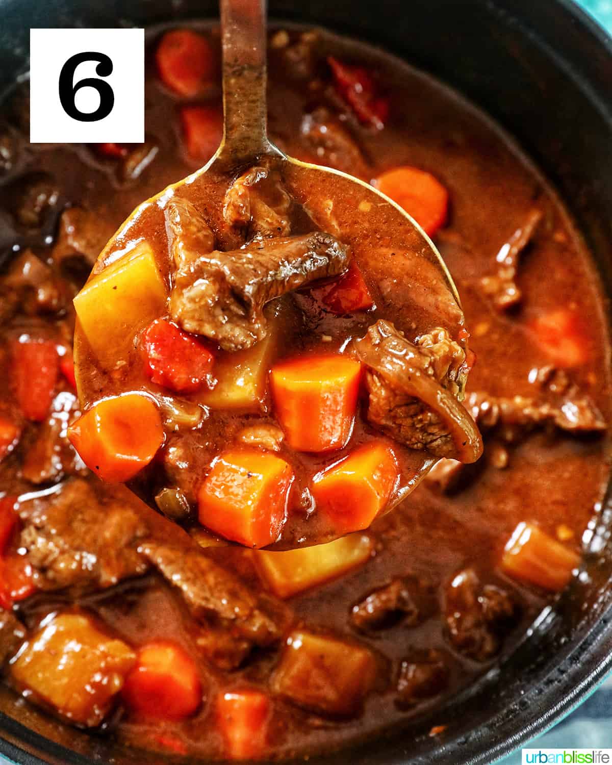ladle full of beef mechado with dutch oven of beef mechado below.