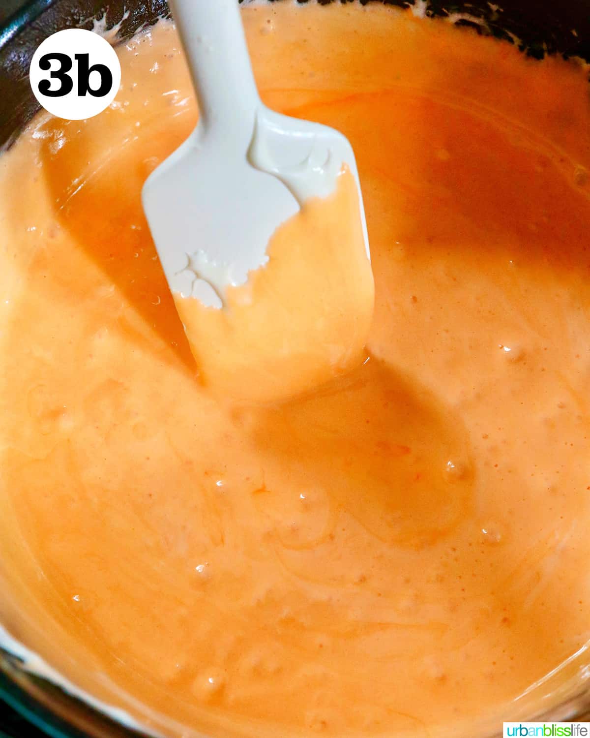 spatula in melted orange marshmallows.
