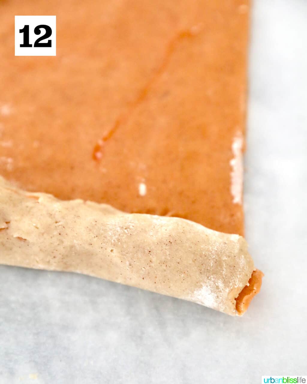 rolling orange cookie dough up