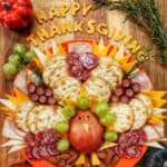 beautiful Thanksgiving turkey charcuterie board with cheese, meat, crackers, and fruit.