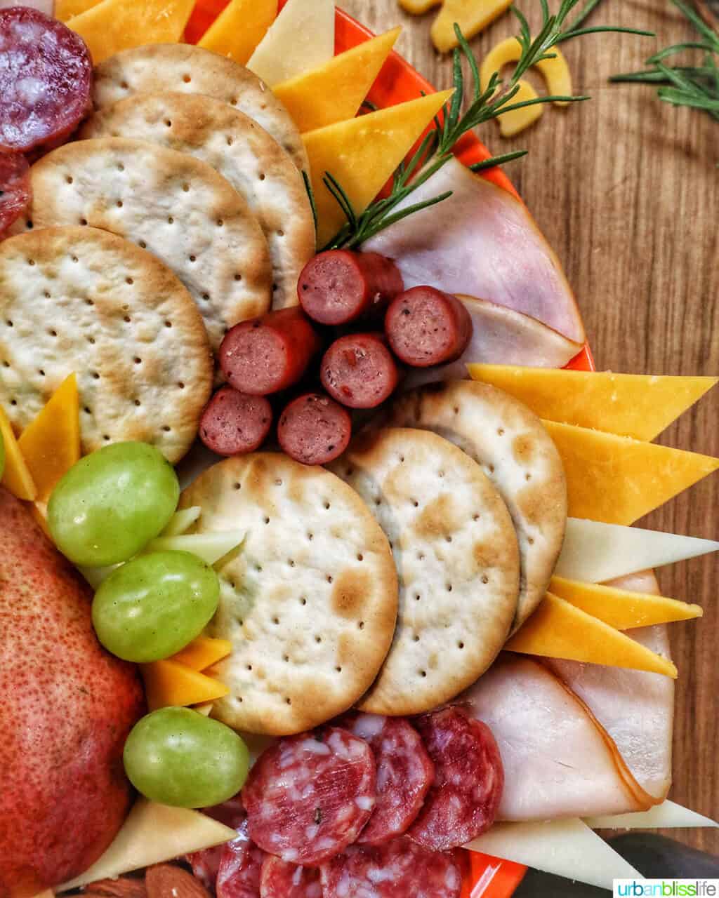 turkey, salami, crackers, cheese, grapes on a Thanksgiving charcuterie board.