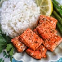 air fryer salmon bites with white rice, asparagus, and lemon slice.