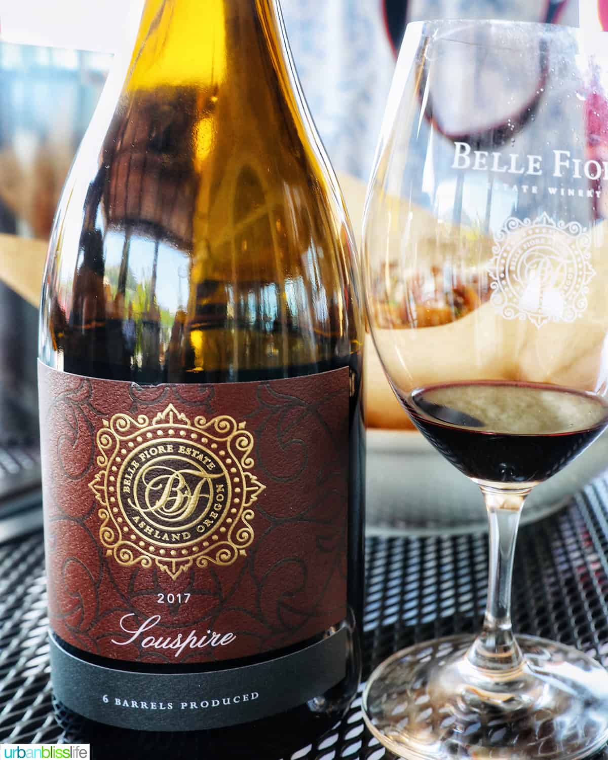 belle fiore winery bottle of souspire wine with glass of red wine next to it.