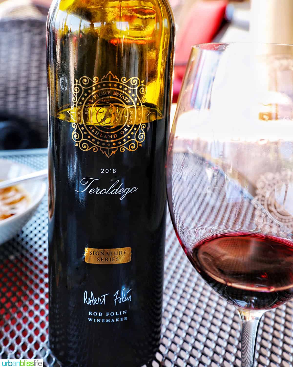 bottle of teradelgo wine with glass of red wine next to it.