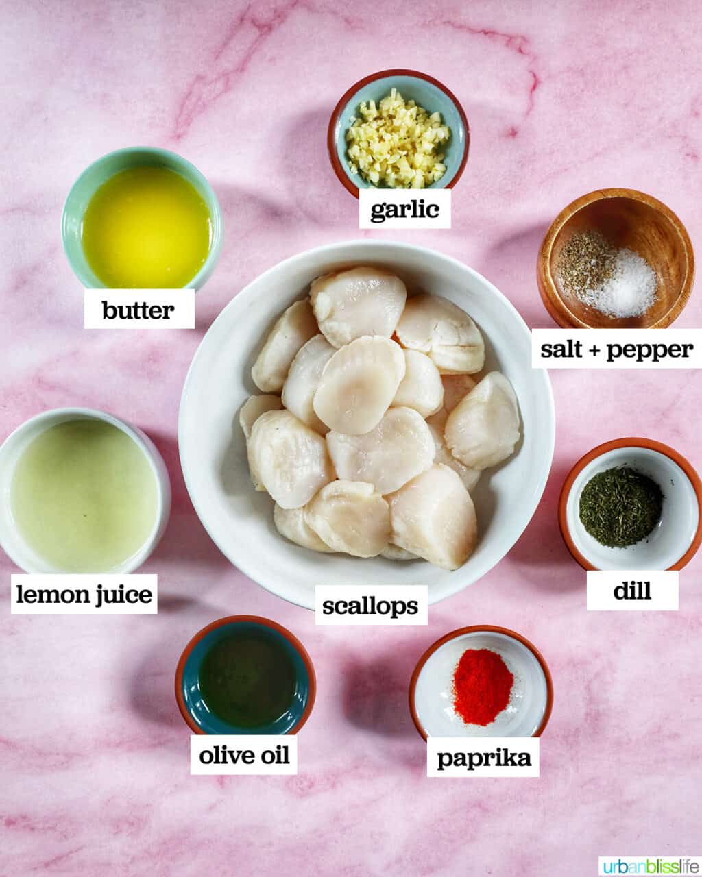 bowls of ingredients to make air fryer scallops on a pink table.
