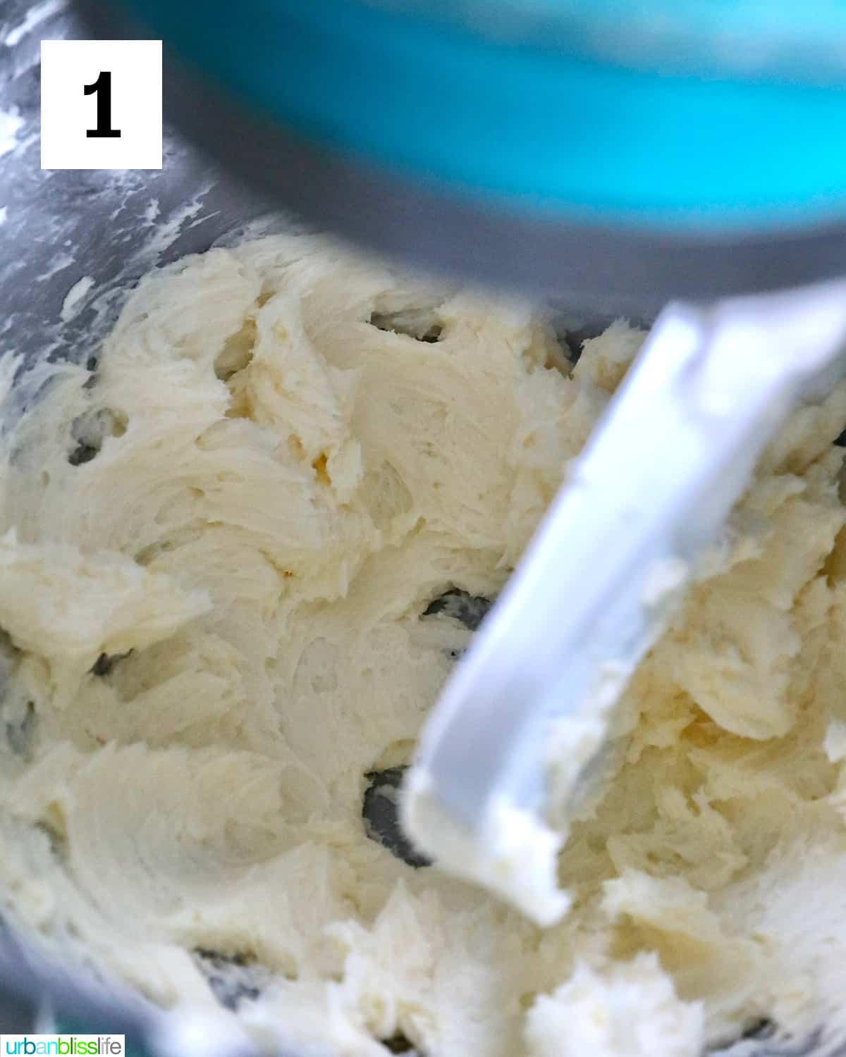 stand mixer beating butter until it's light yellow and fluffy for buttercream frosting.