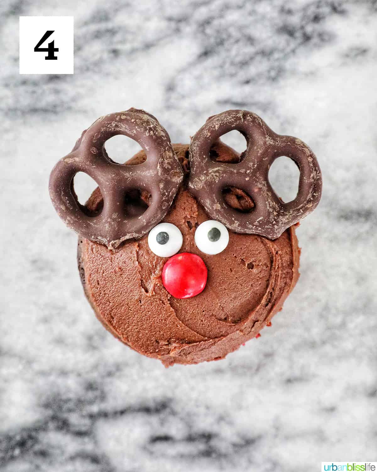 finished decorated reindeer cupcake on a marble counter.