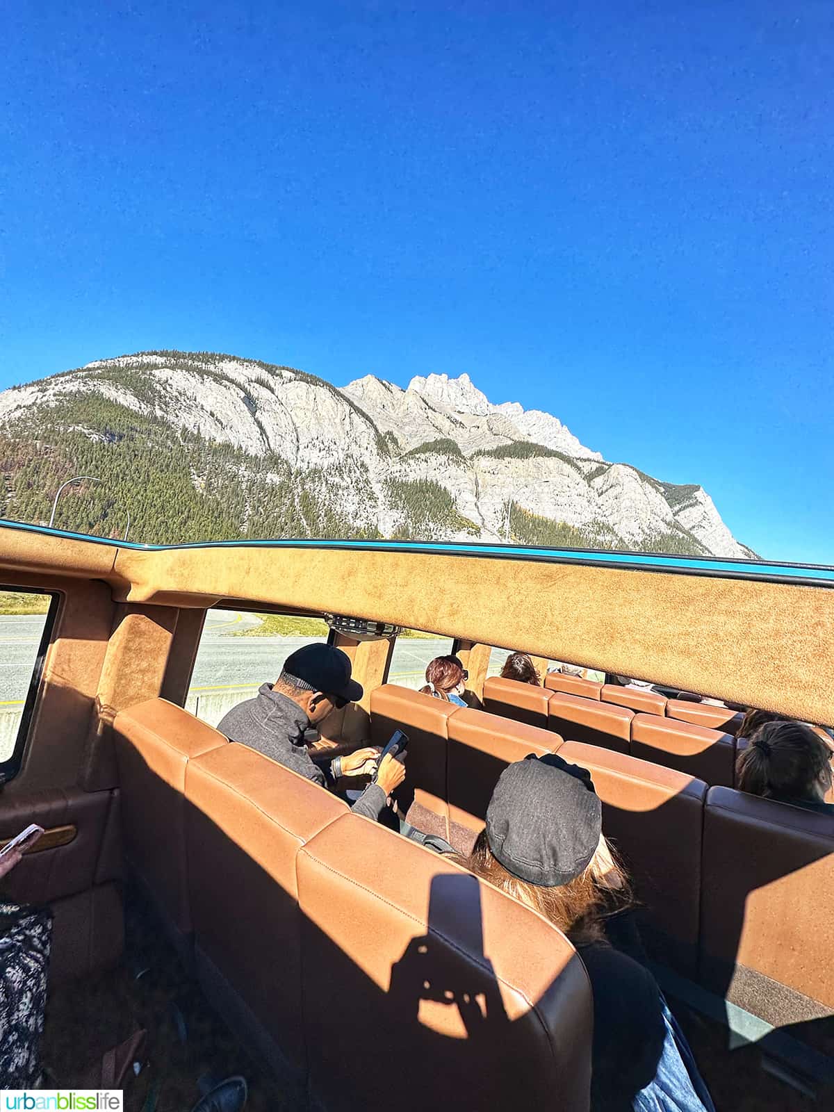 Open Top Touring vehicle with mountain in the background.