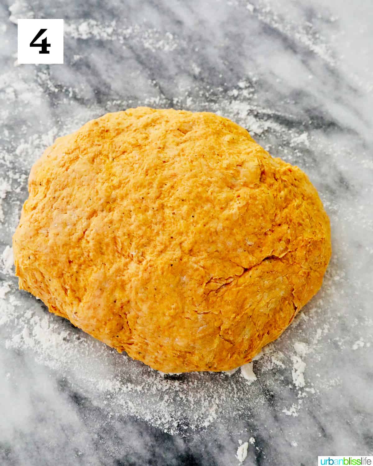 pumpkin gnocchi dough on a marble countertop.