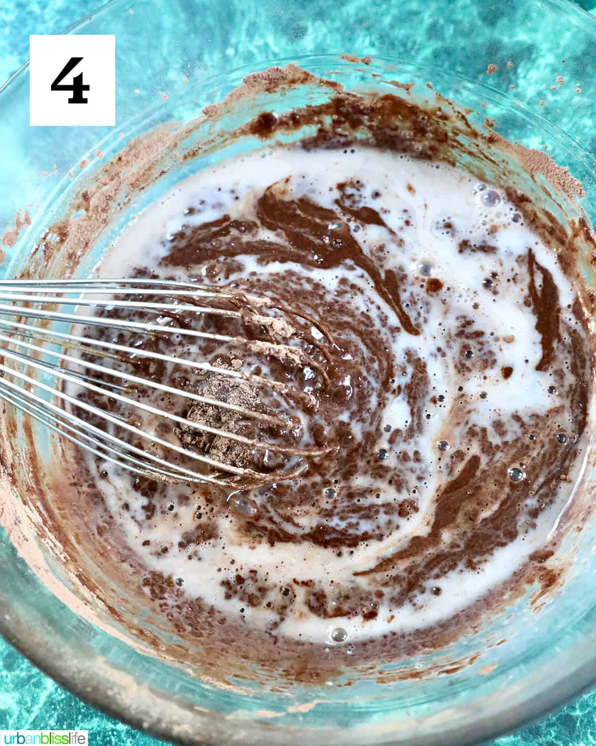 whisking together ingredients in a large bowl to make reindeer cupcakes.