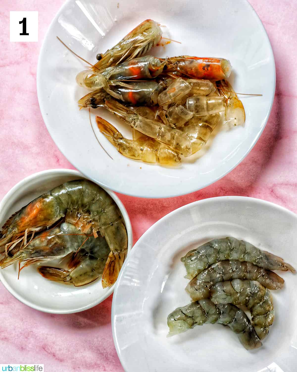 bowls of prawns, prawn heads, shells, and tails, and shelled prawns on a pink table.