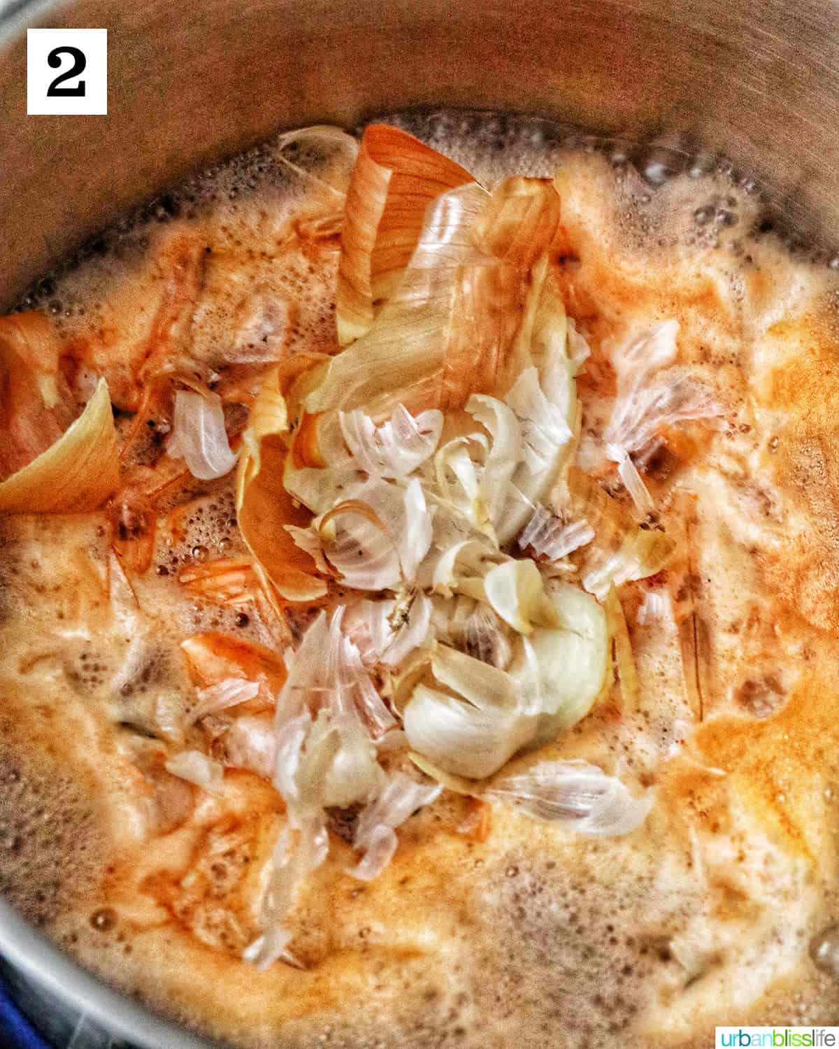 prawn shells, heads, tails, and onion and garlic shells in water creating a prawn stock.