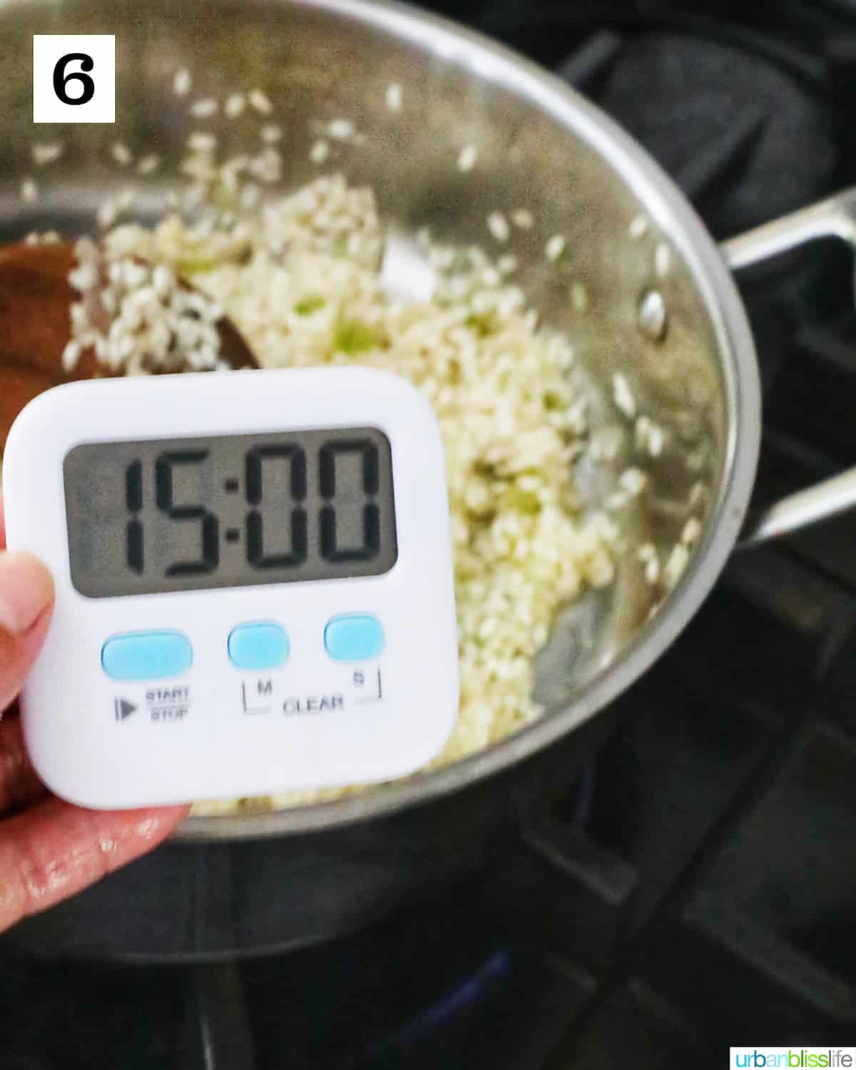 timer set for 15 minutes above a pan with onions and garlic simmering.