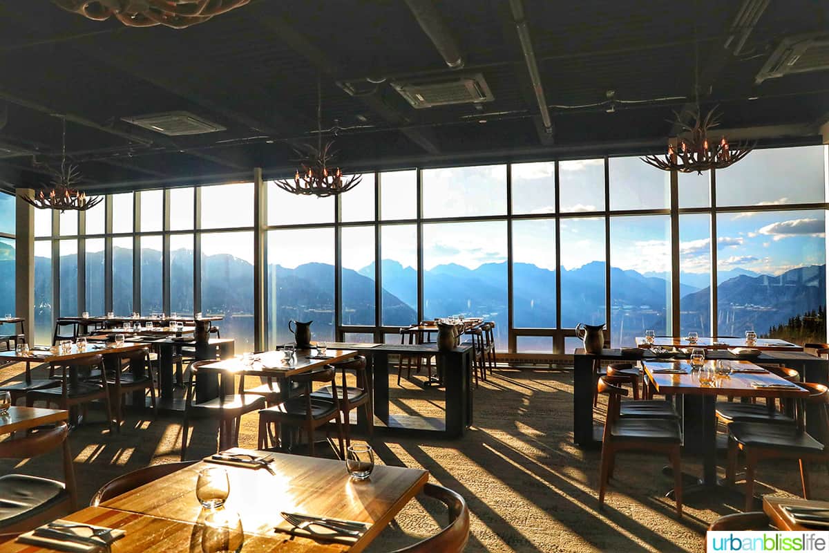Sky Bistro restaurant with floor to ceiling windows and views of the mountains in Banff Canada.