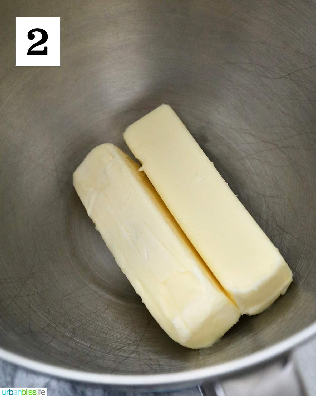 two sticks of butter in a stand mixer bowl.