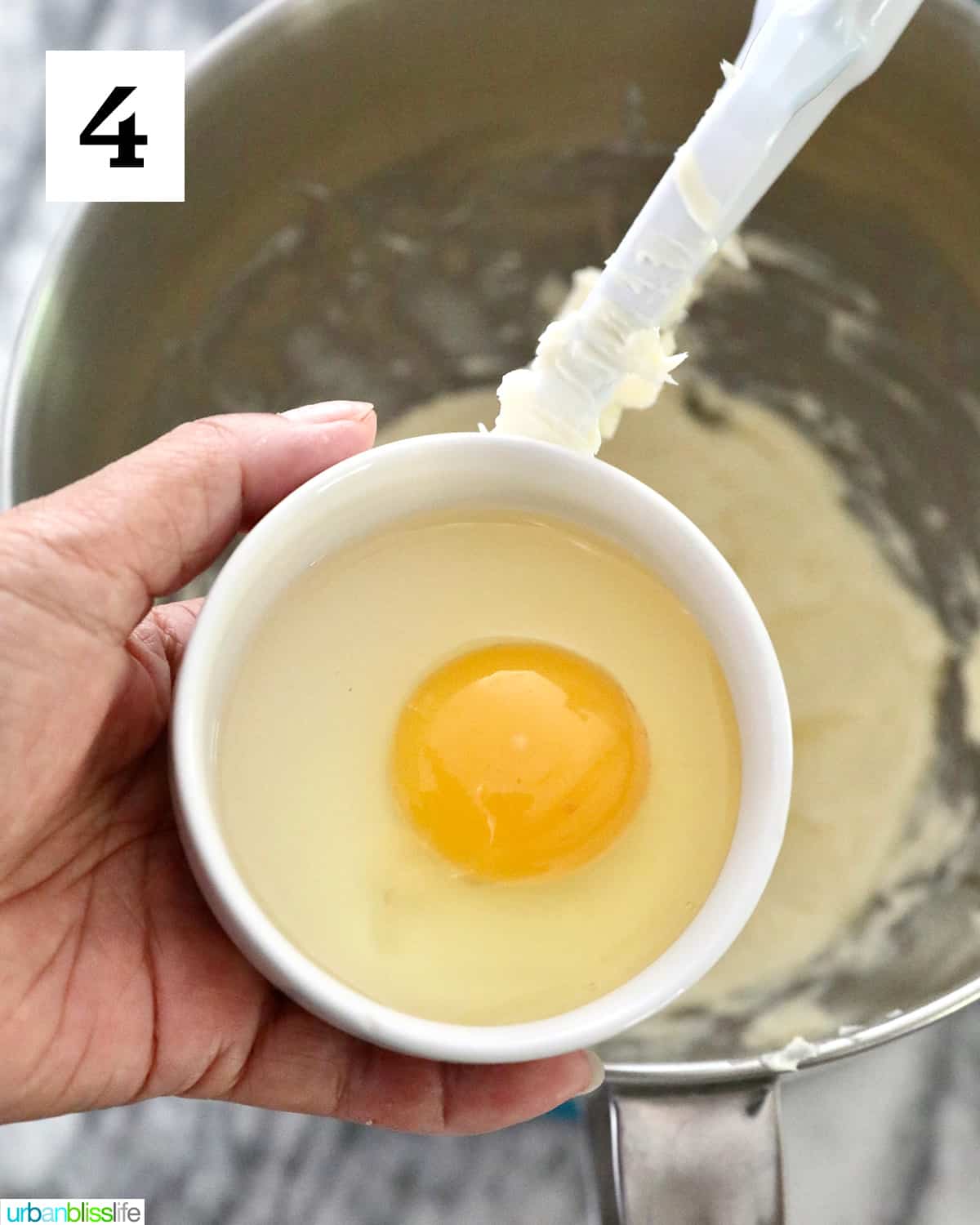 adding an egg to the sugar cookie batter in a stand mixer.