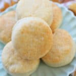 air fryer biscuits stacked on a plate.