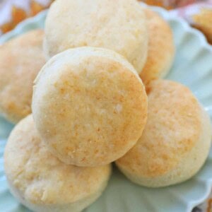 air fryer biscuits stacked on a plate.