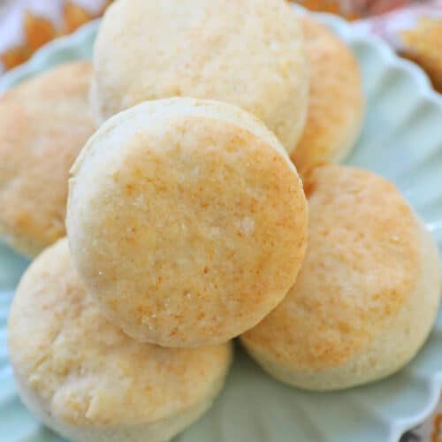 air fryer biscuits stacked on a plate.