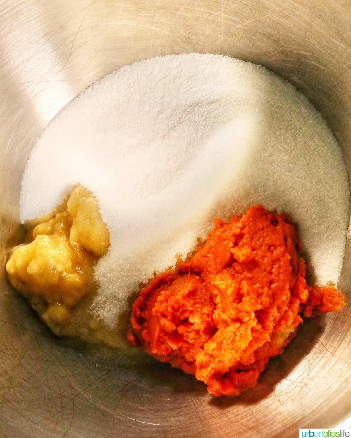 pumpkin puree, mashed bananas, and sugar in a stand mixer bowl.