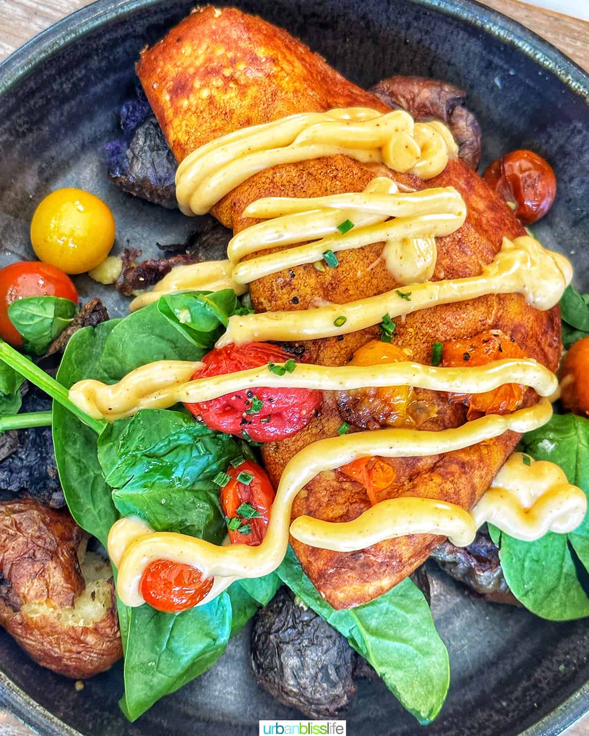 vegan breakfast with tomatoes and greens at Farm and Fire restaurant in Banff Canada.
