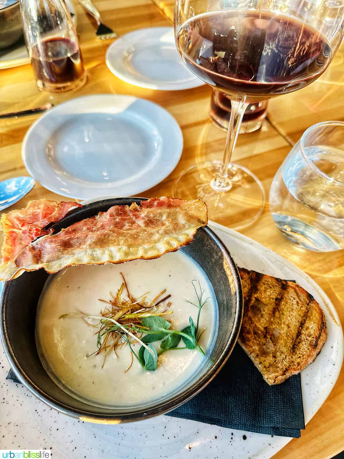truffled cauliflower soup with bread and a glass of wine.