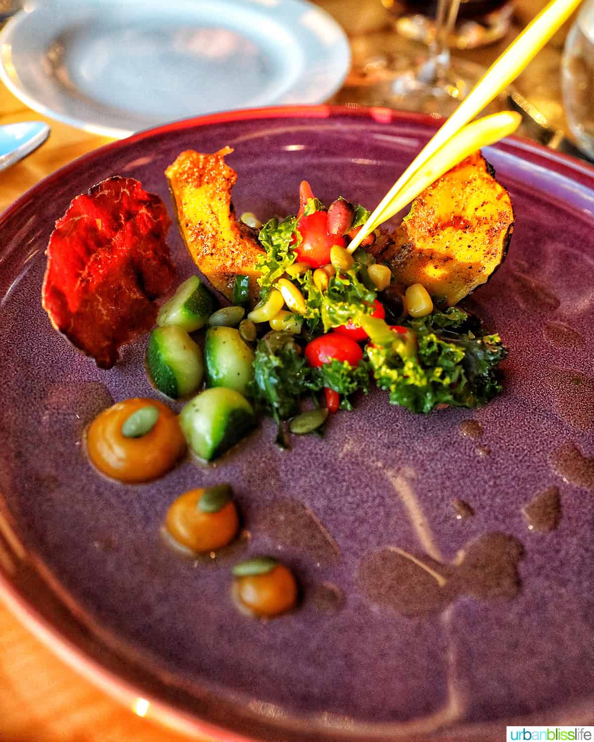 Three Sisters Salad on a maroon plate in Sky Bistro Banff Canada.