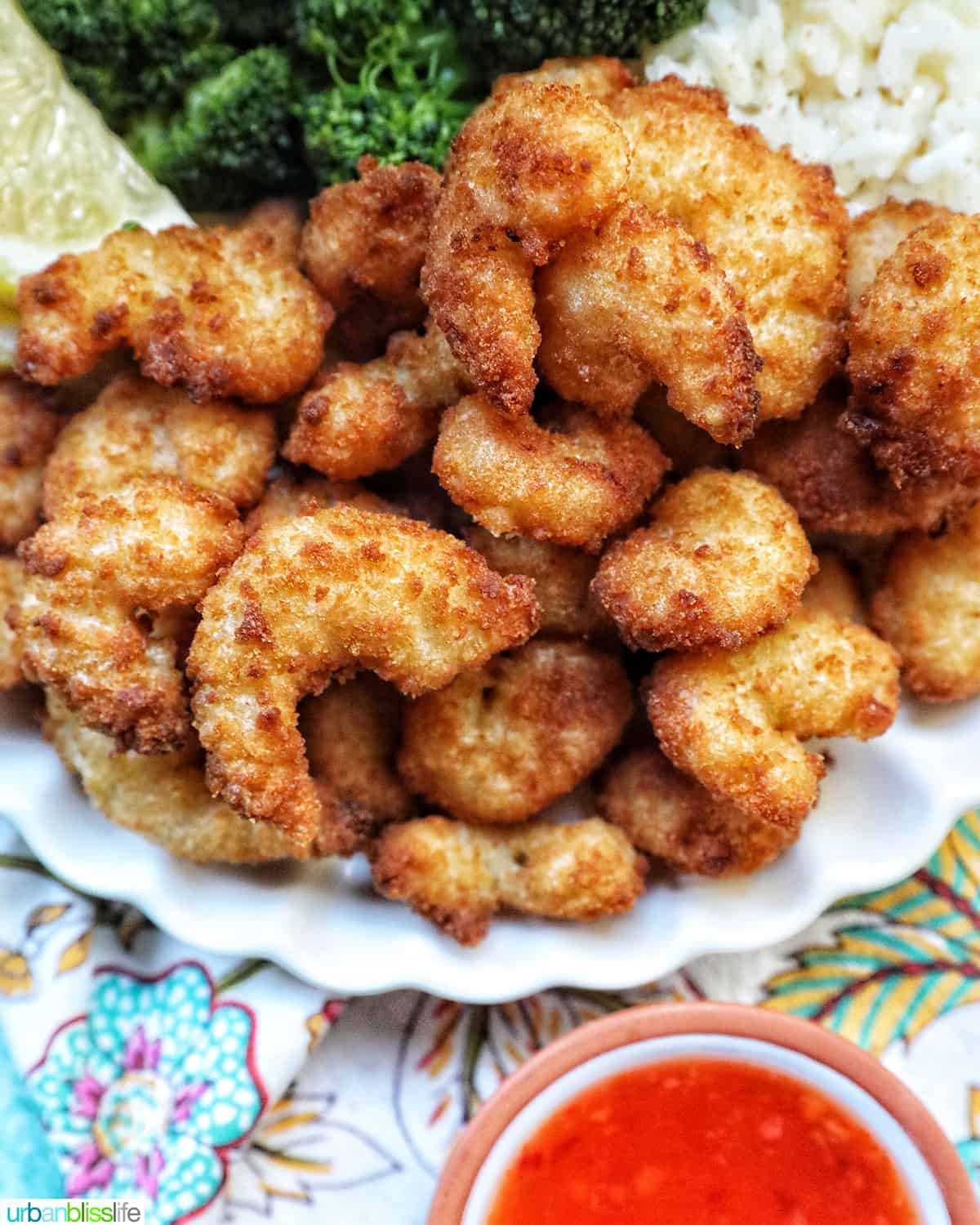 plate of air fryer popcorn shrimp with side of sauce.