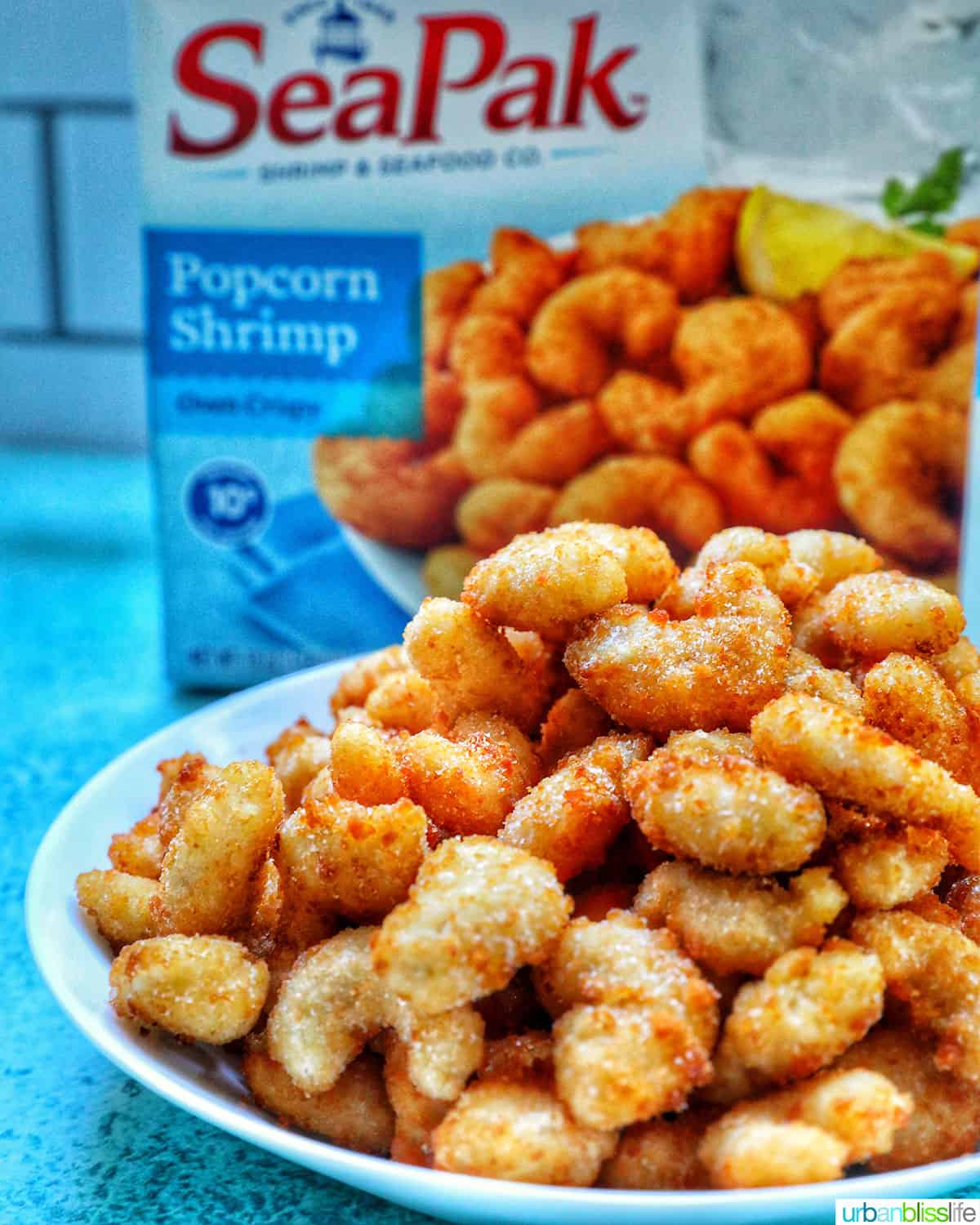 bowl of popcorn shrimp with packaging.