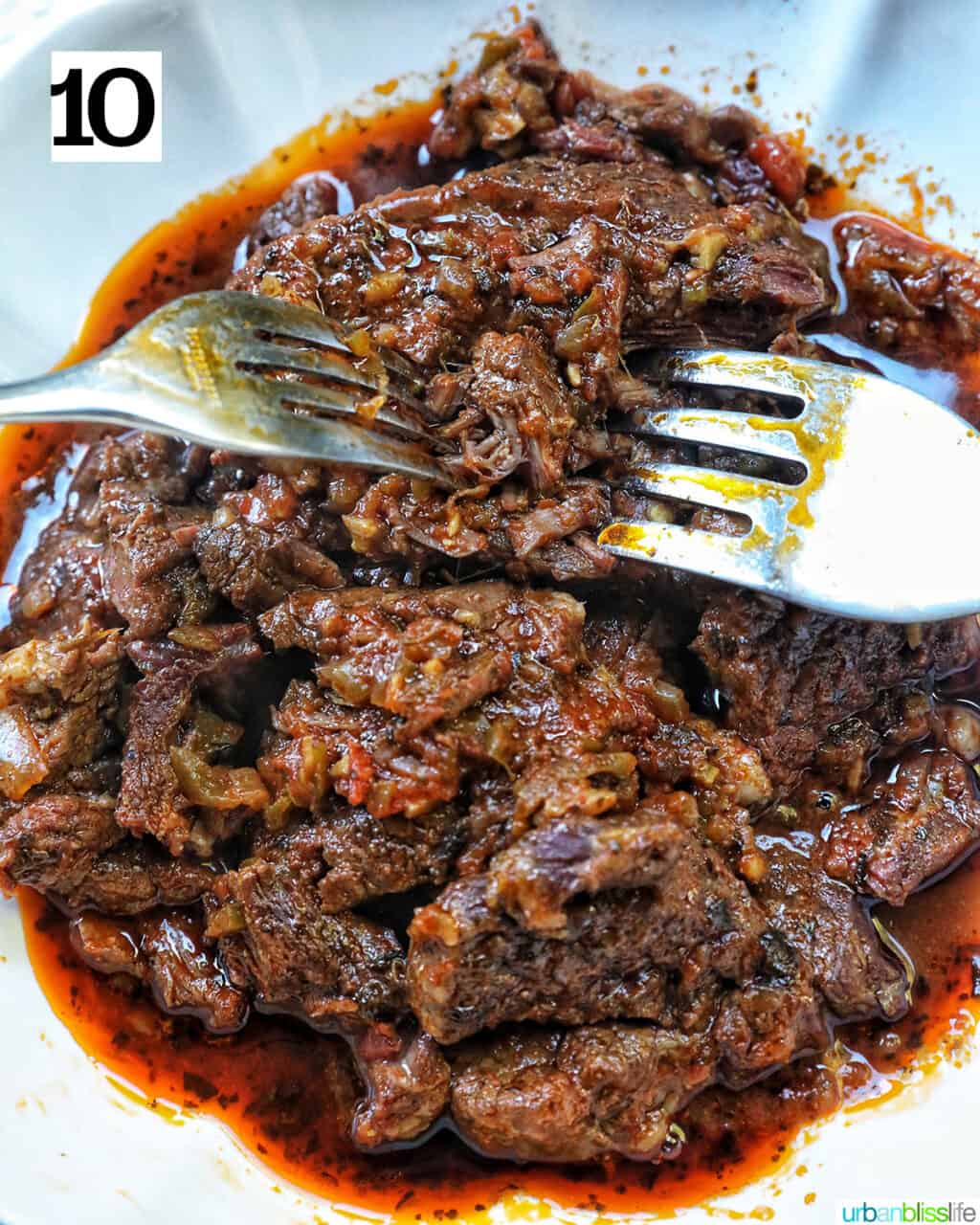 two forks shredding Mexican beef.