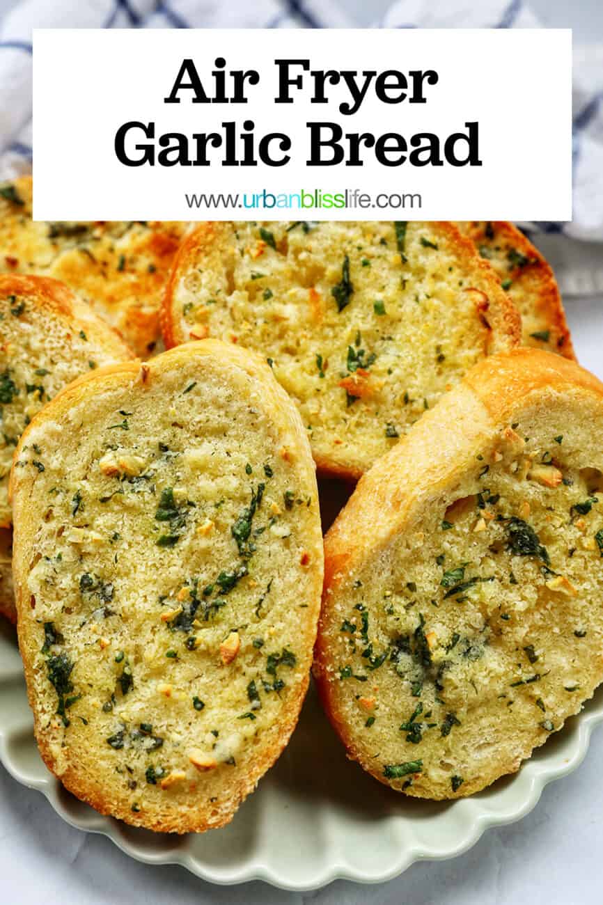 plate full of sliced garlic bread with kitchen towel with title text overlay.