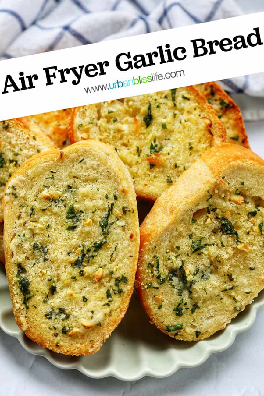 plate full of sliced garlic bread with kitchen towel with title text overlay.