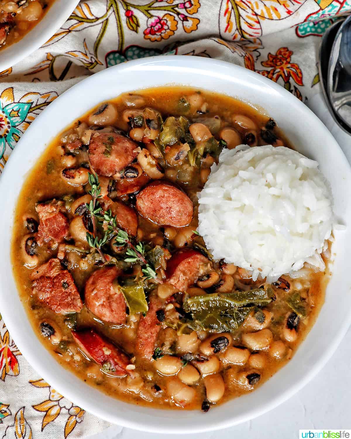 Instant Pot black eyes peas with scoop of white rice in a white bowl.