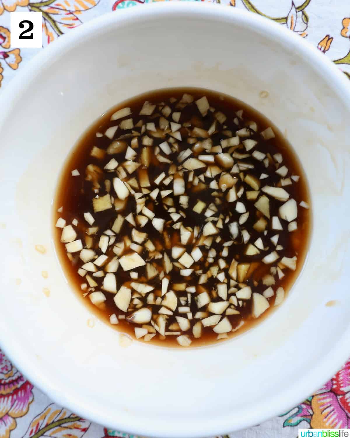 white bowl with pad thai sauce, and minced garlic and ginger.