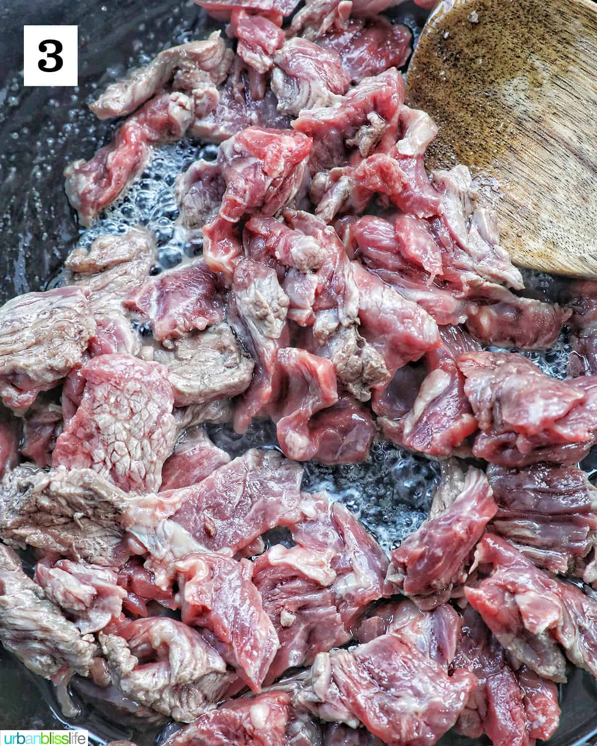 cooking steak in a cast iron skillet.