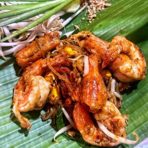 shrimp pad thai in Bangkok, on a bed of banana leaves.