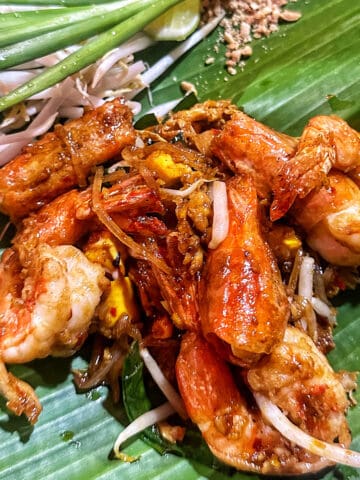 shrimp pad thai in Bangkok, on a bed of banana leaves.