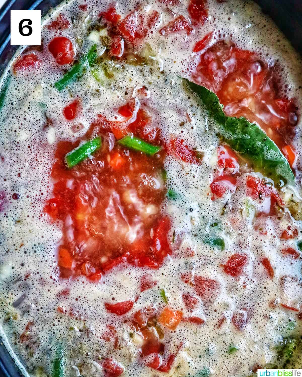 chicken minestrone soup boiling in a dutch oven.