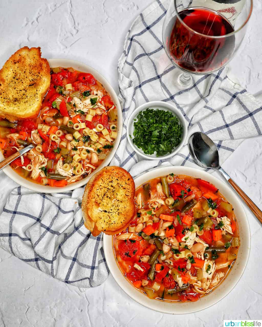 two bowls of Chicken Minestrone Soup with side of garlic bread.
